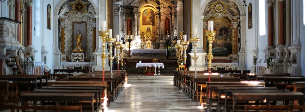 the inside of a church filled with lots of pews