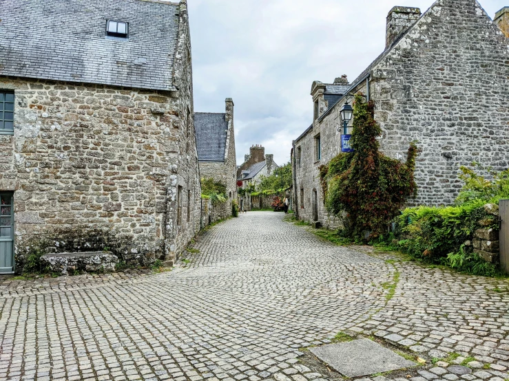 a cobblestone road leading to stone buildings in france