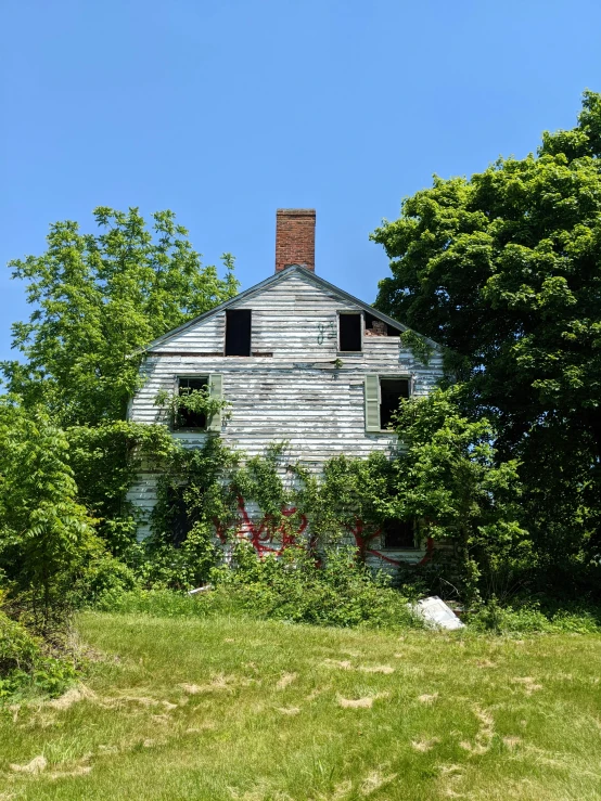 an old house sitting in a tree filled park