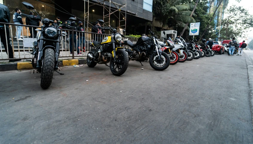 a row of motorcycles lined up outside of a building