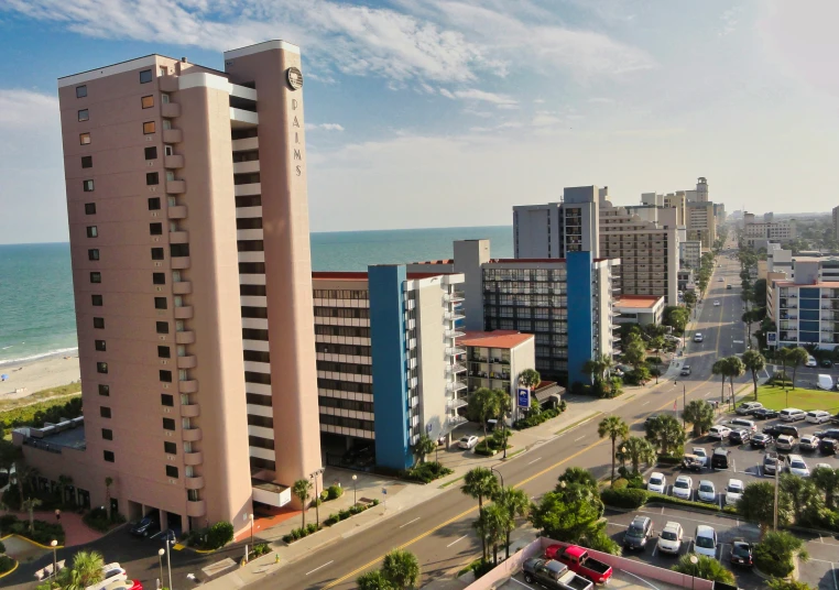 the buildings are tall and the parking lot is wide