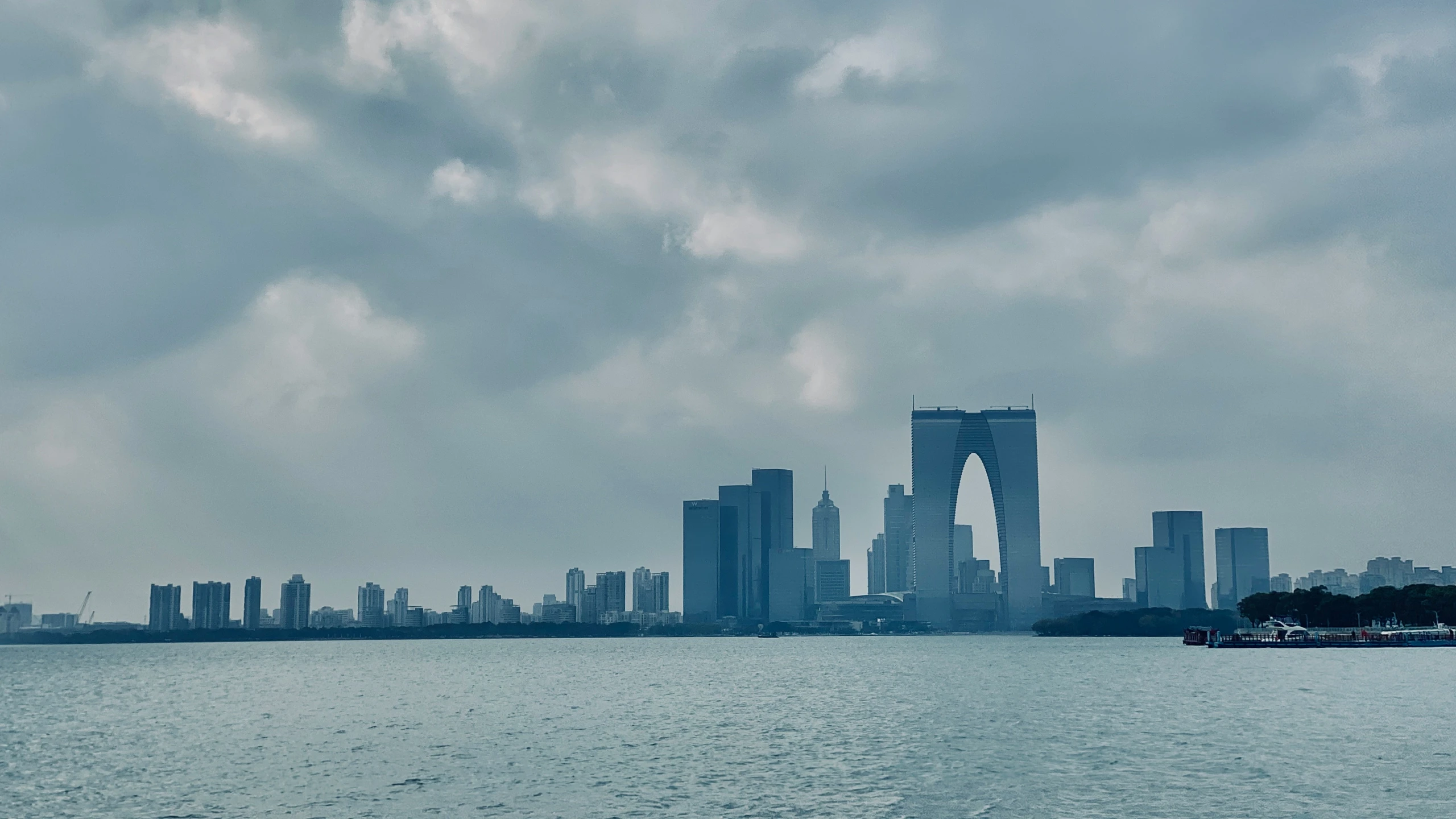 a body of water that has some buildings in the background