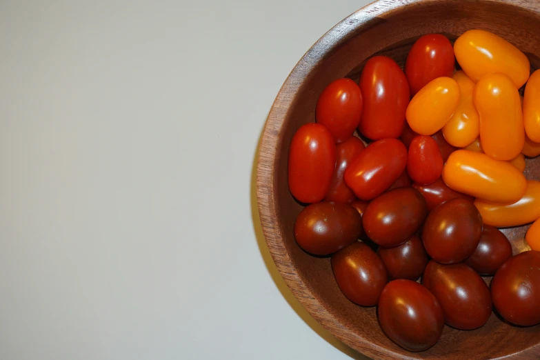 a close up of tomatoes and peppers in a bowl