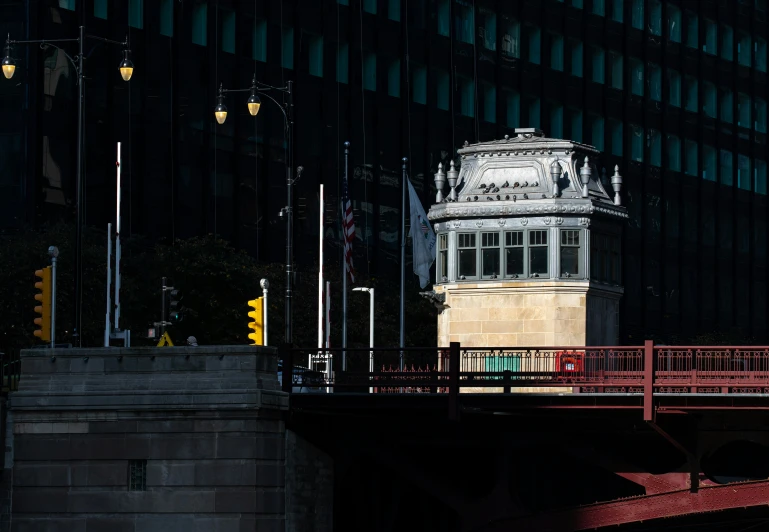 a red walkway crossing over a bridge with a tower in the background