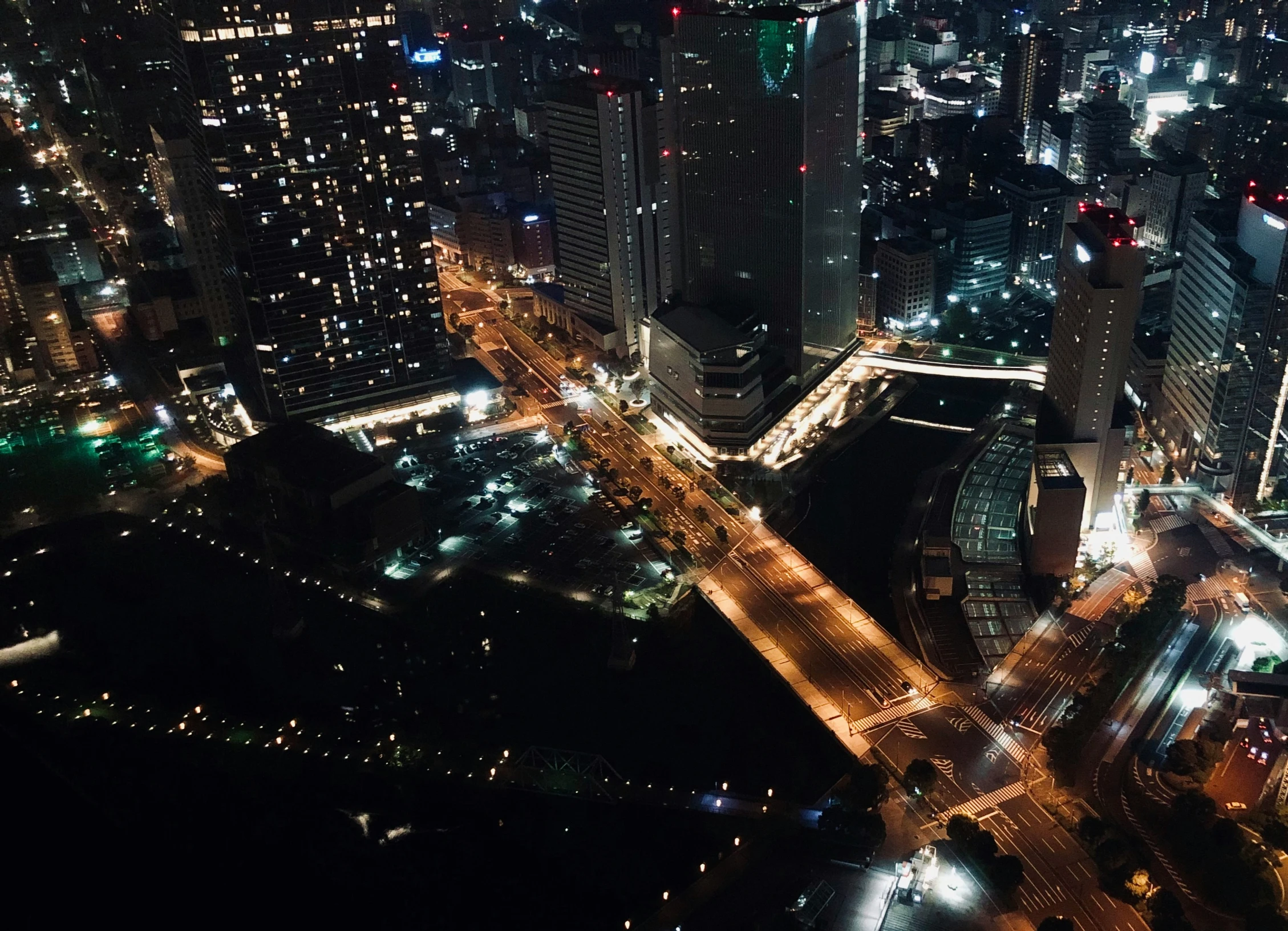 an aerial po shows some buildings, roads and streets at night