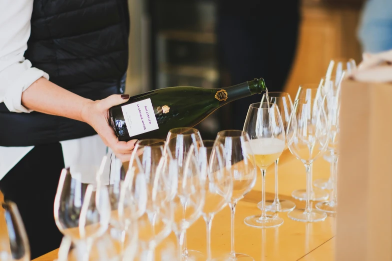 the woman is pouring champagne into many wine glasses