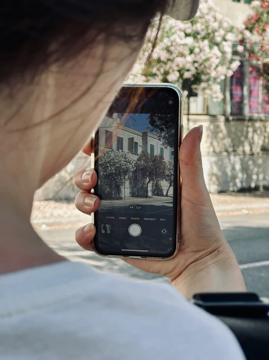 a woman is using her cell phone to take pictures