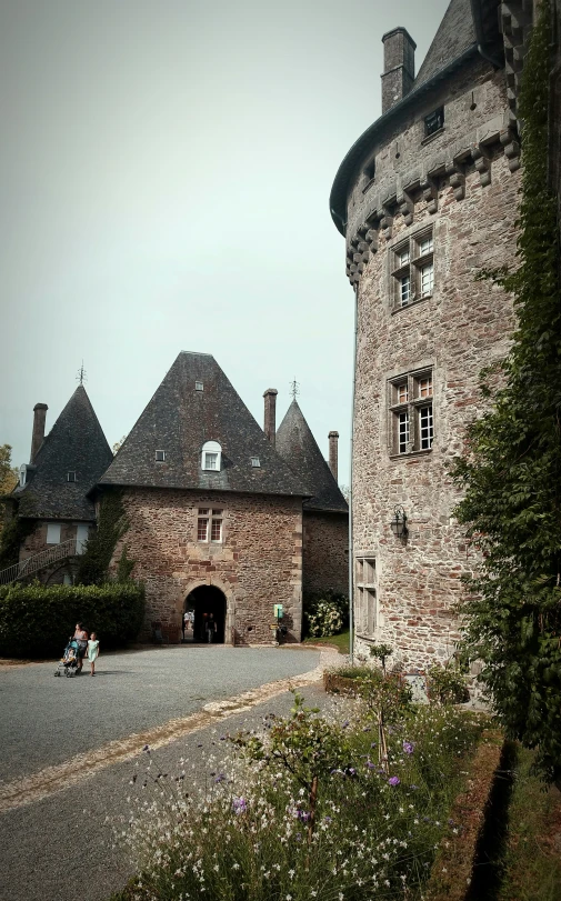 two people are riding motorcycles by a castle