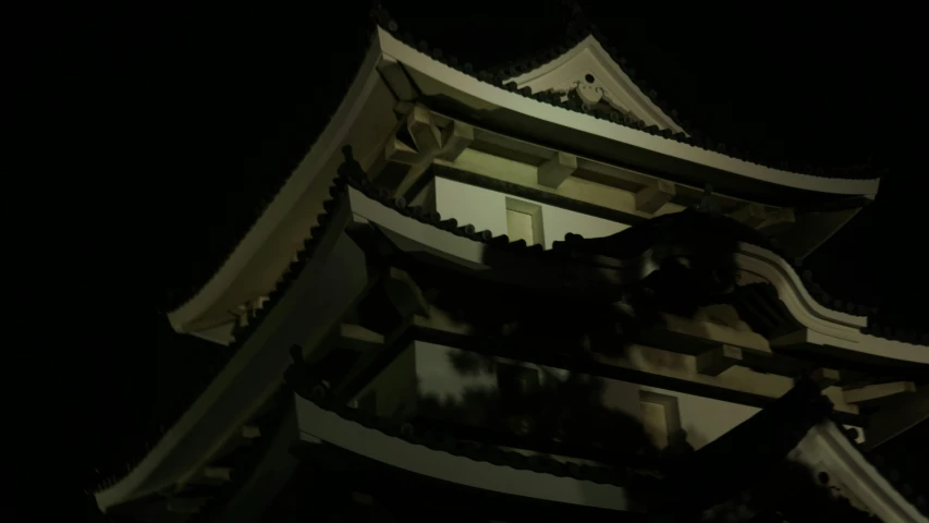 a tall asian tower lit up at night