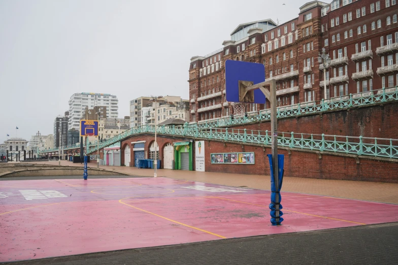 colorful art exhibit in front of old brick buildings