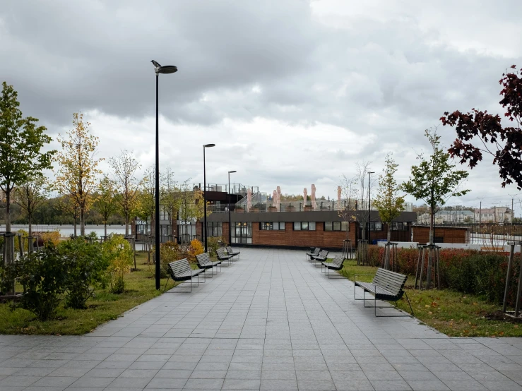 an empty paved path is bordered by a building