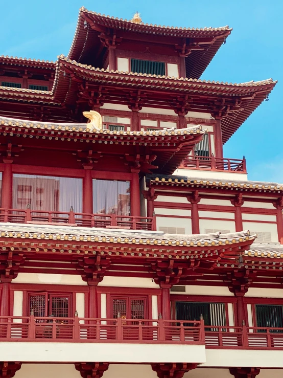 a building that has an intricate roof with decorative pillars