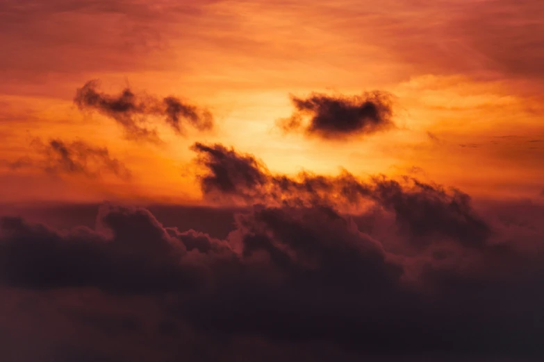 the sky is orange and pink at sunset