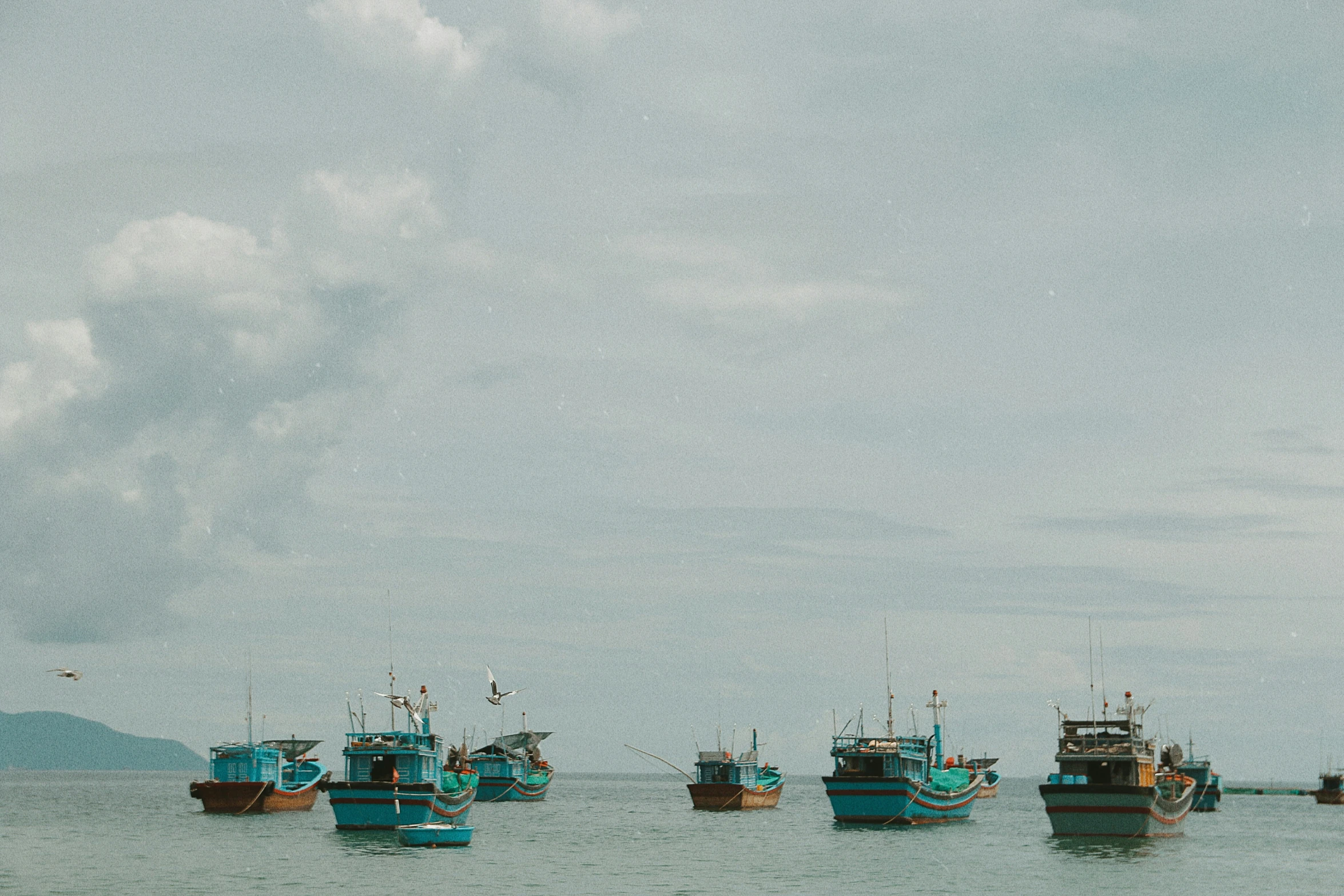 several different colored boats in the water