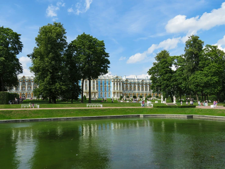 a park area with a large building and water