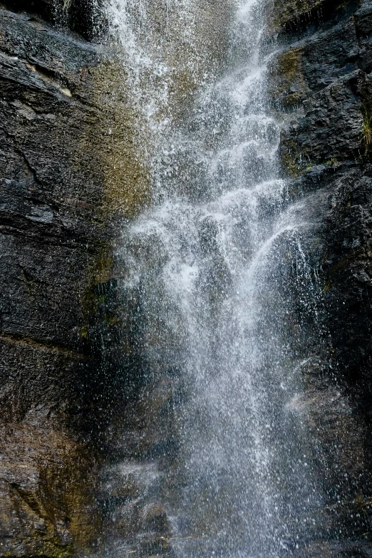 water pouring down over the top of a waterfall