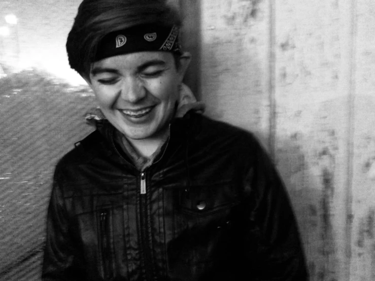 a person wearing a hat and a jacket smiling