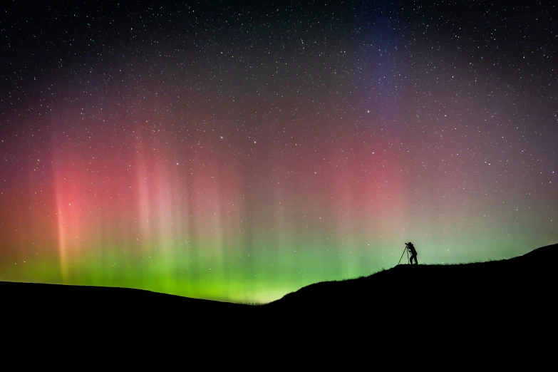 a man looks up at the stars in a night sky