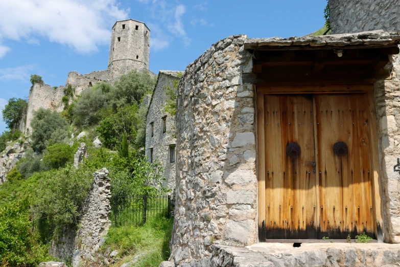 an old stone building that has been built on top of the hill