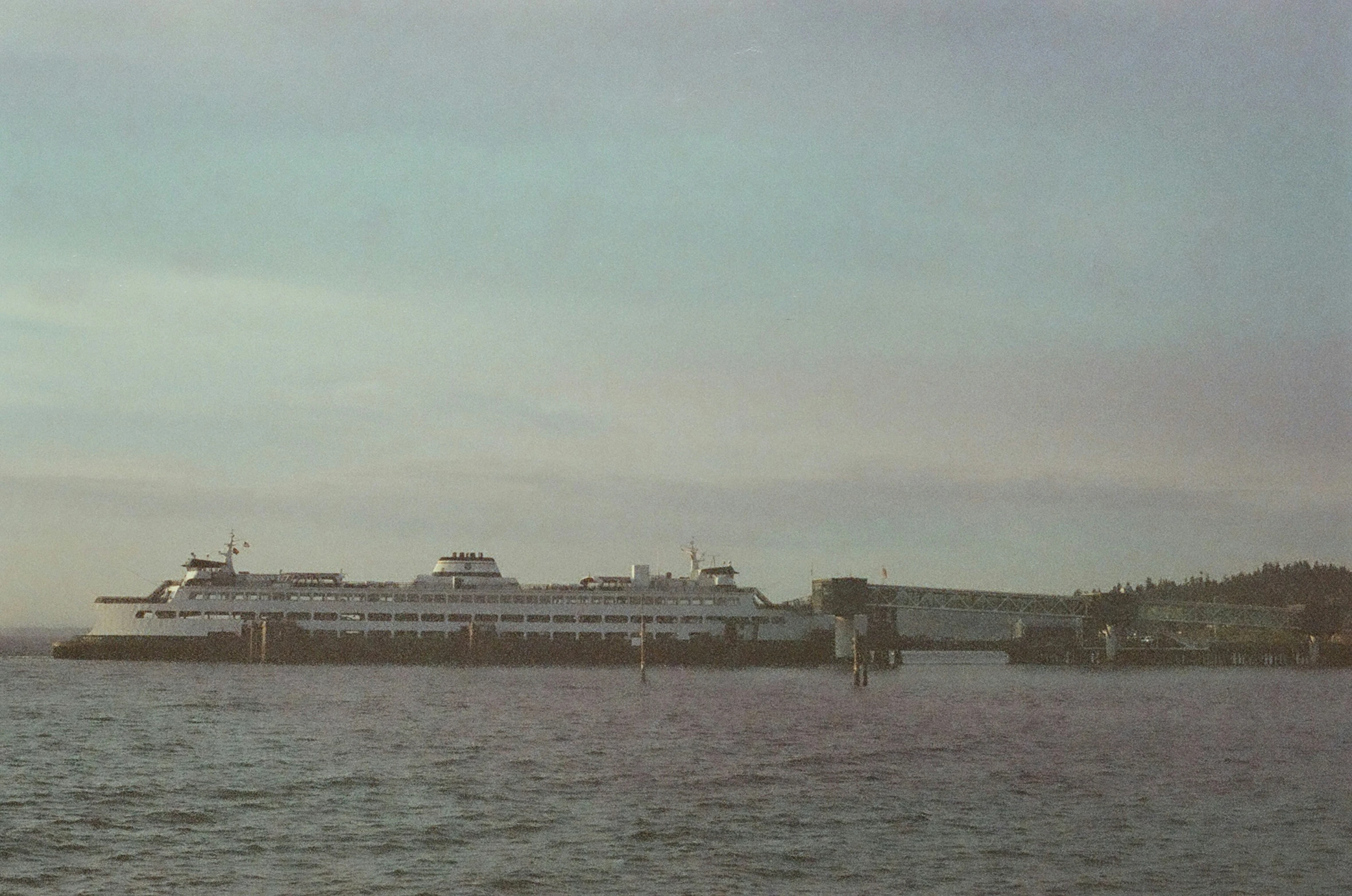 the large ferry is parked on the shoreline