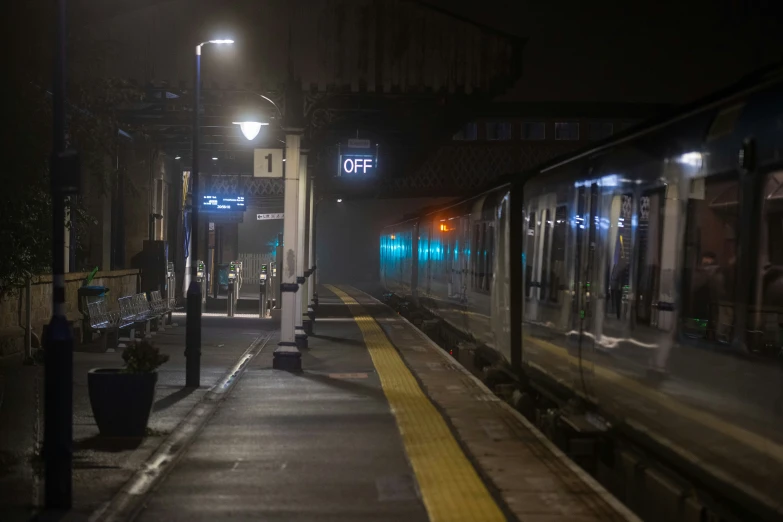 a train is going down the tracks in the dark