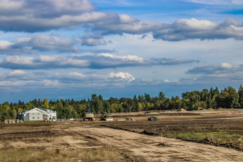 a field with a barn and a road