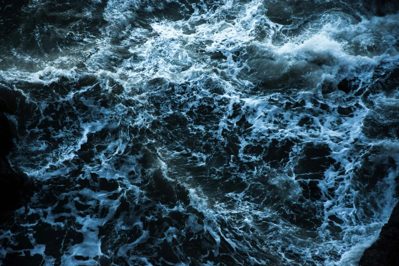 some dark blue water waves and black background