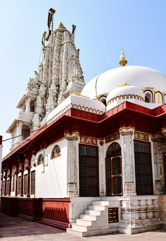 a temple that has many white, red and gold details