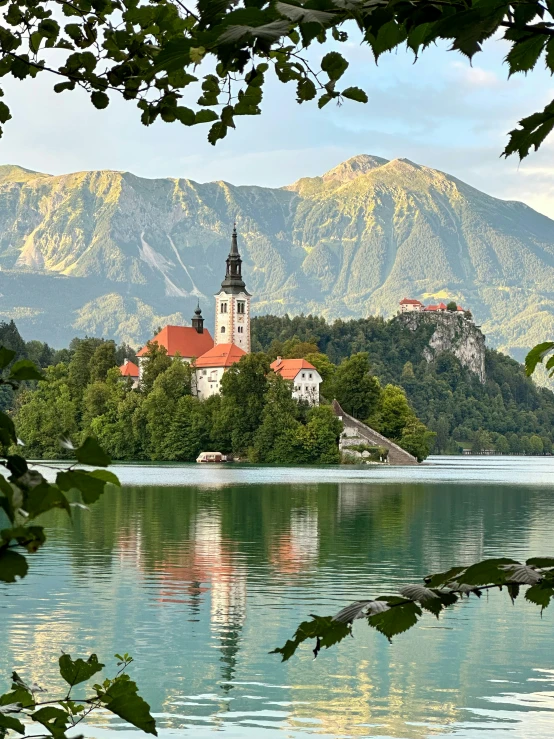 a building in the middle of a lake, with a clock tower