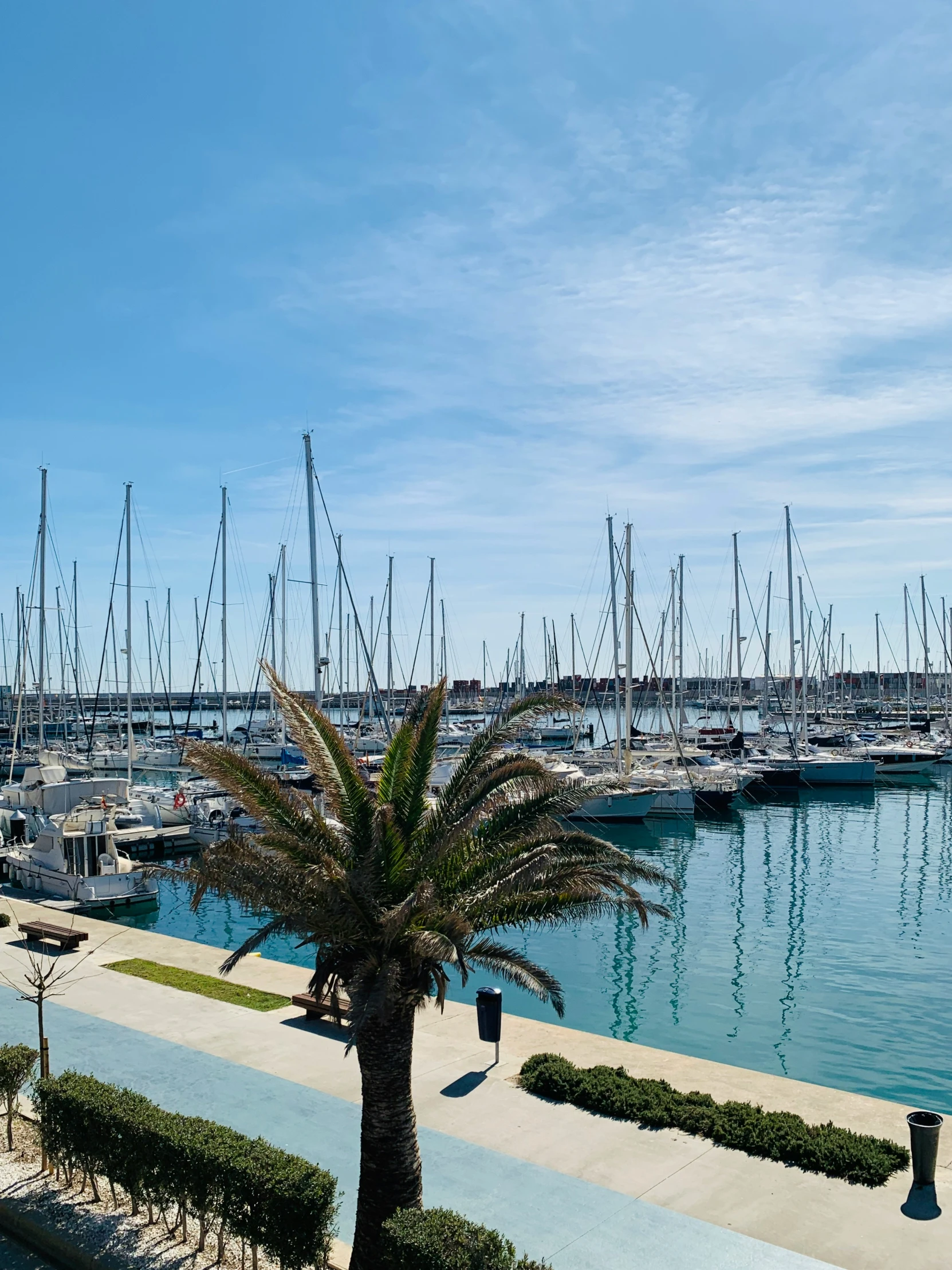 boats and ships sit on the water in the harbor