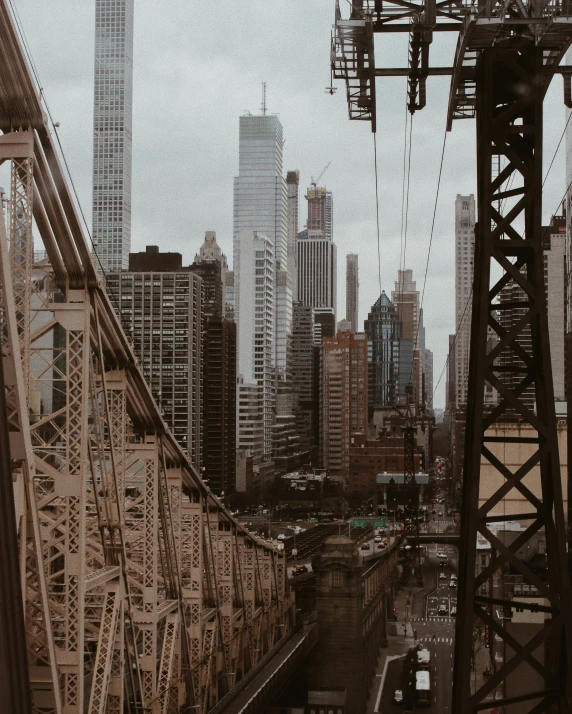 a city skyline is seen behind a bridge