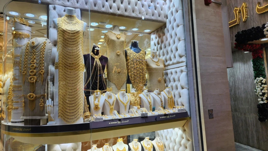 the window display is decorated with gold and diamond jewelry