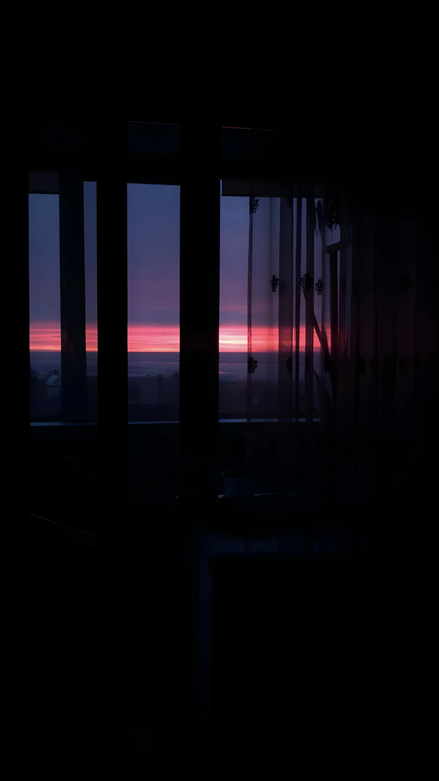 view out of two large windows at the sunset