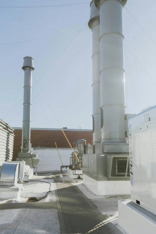 large industrial pipe blowing works are on the roof of a building