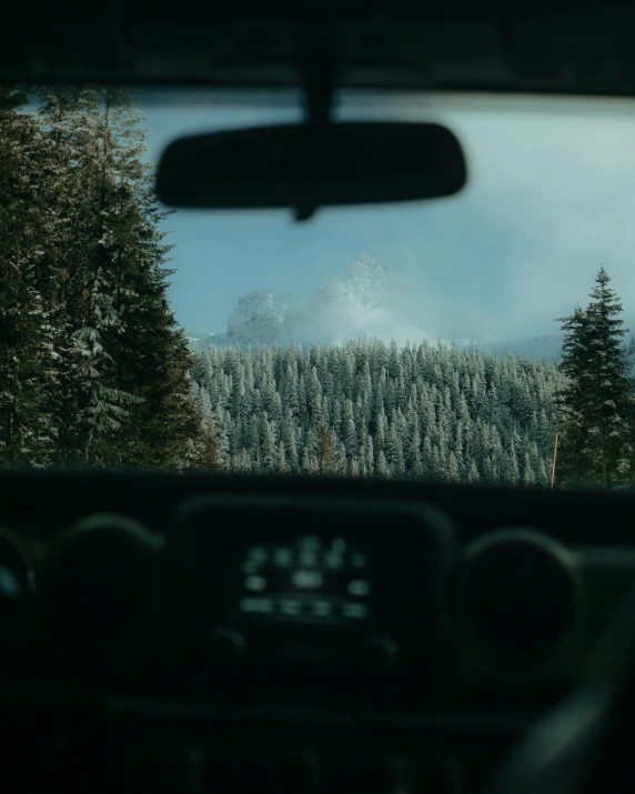 a mountain is seen from inside a car