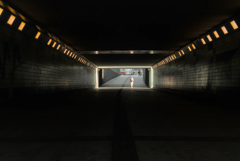 people in the tunnel for walkers or a light up sign