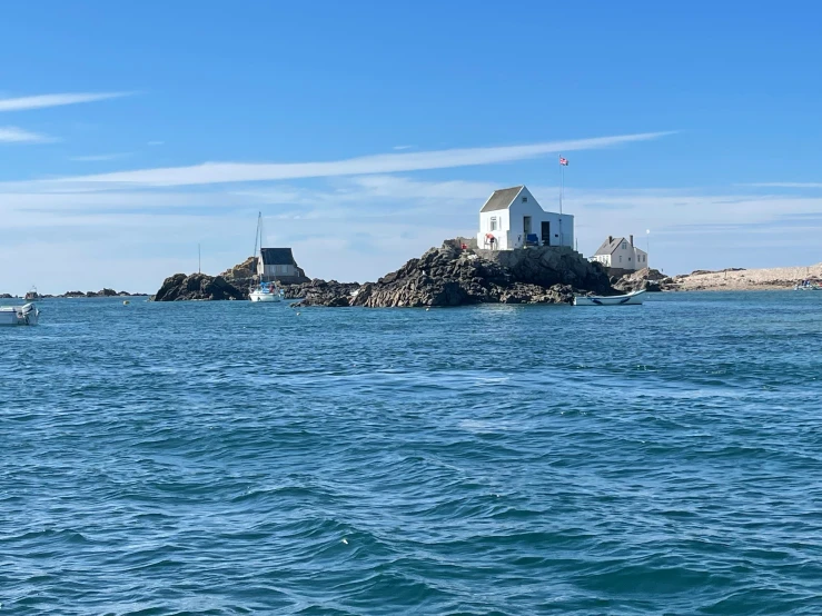 small lighthouse surrounded by small water sports boats