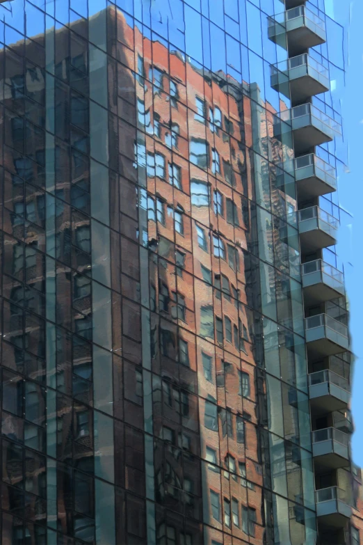 a large building in the reflection of another one