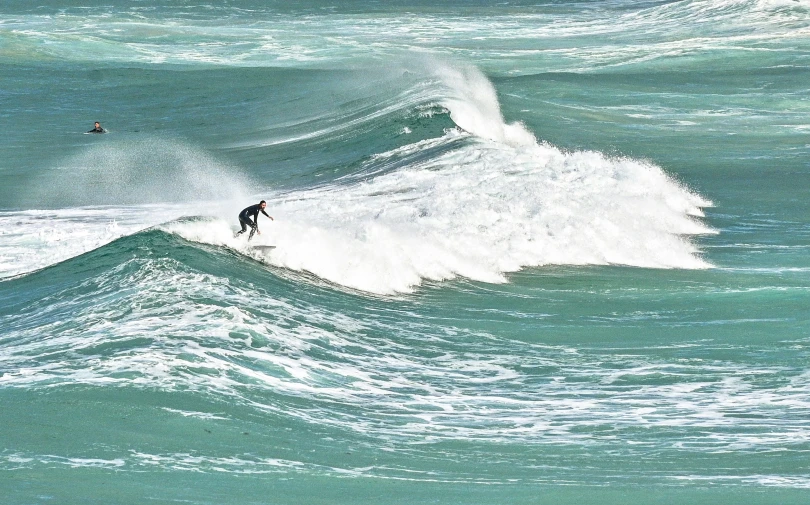 a man on a surfboard riding a wave in the ocean