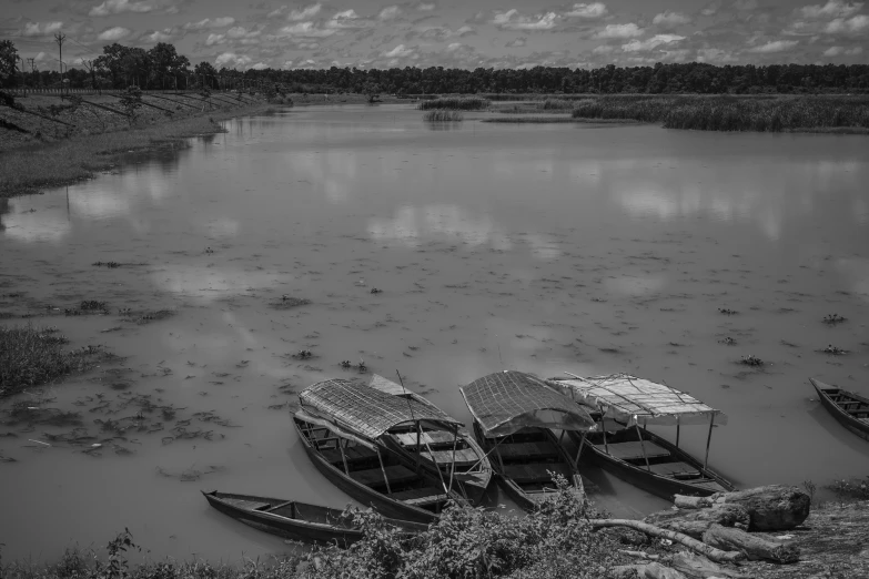 several small boats in the water with sky in background