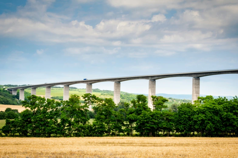 a bridge in the middle of a vast field