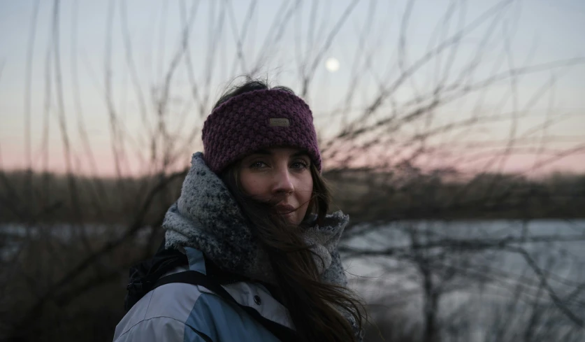 a woman with long hair in a winter hat