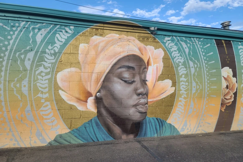 a mural of a woman wearing a turban on a wall