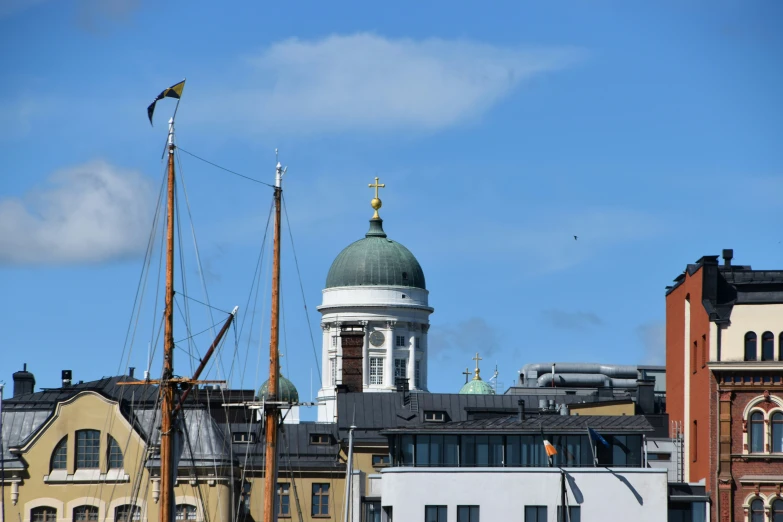 a tall building with a tower on top next to other buildings