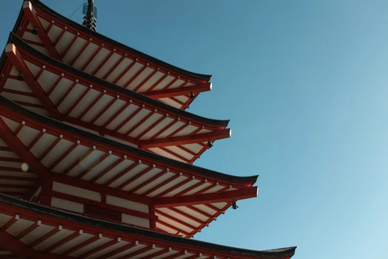 three tall japanese buildings are standing near each other