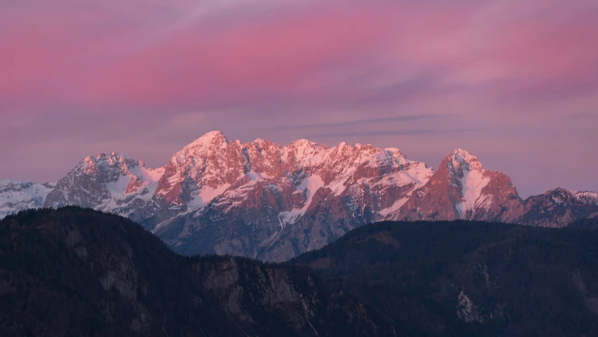 a mountain range with snow capped mountains on either side