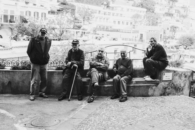 black and white pograph of men sitting outside