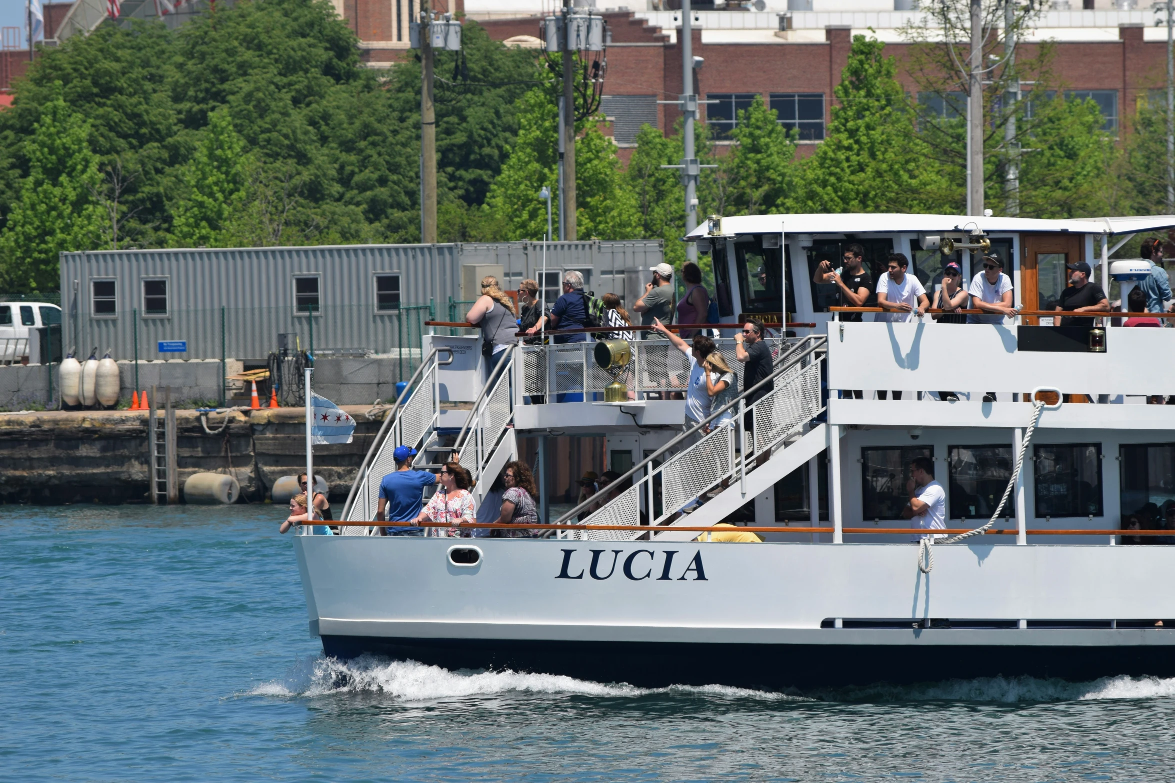 a boat with a large crowd going through water