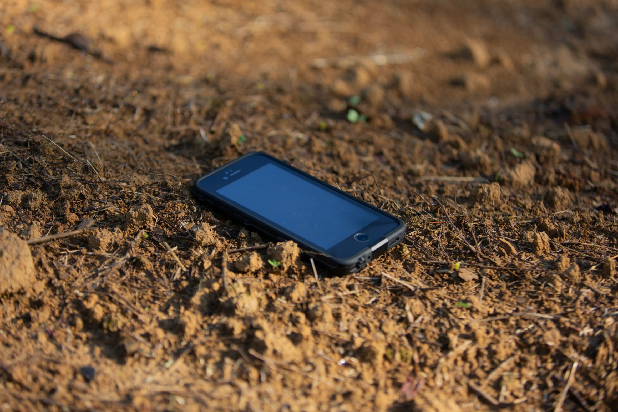 a phone laying in the ground on it's side