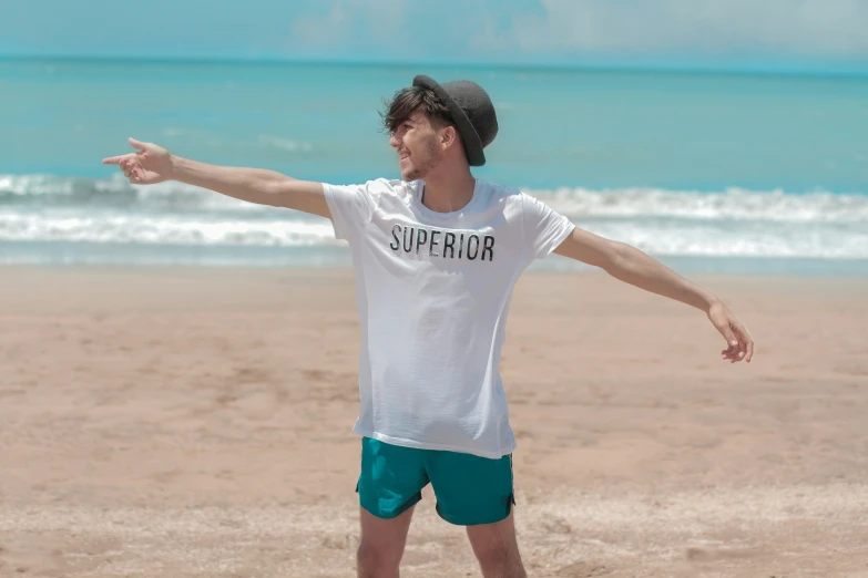 a person standing on a beach with a frisbee in their hand